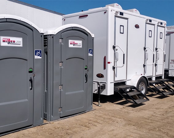porta-potties next to portable toilet trailer